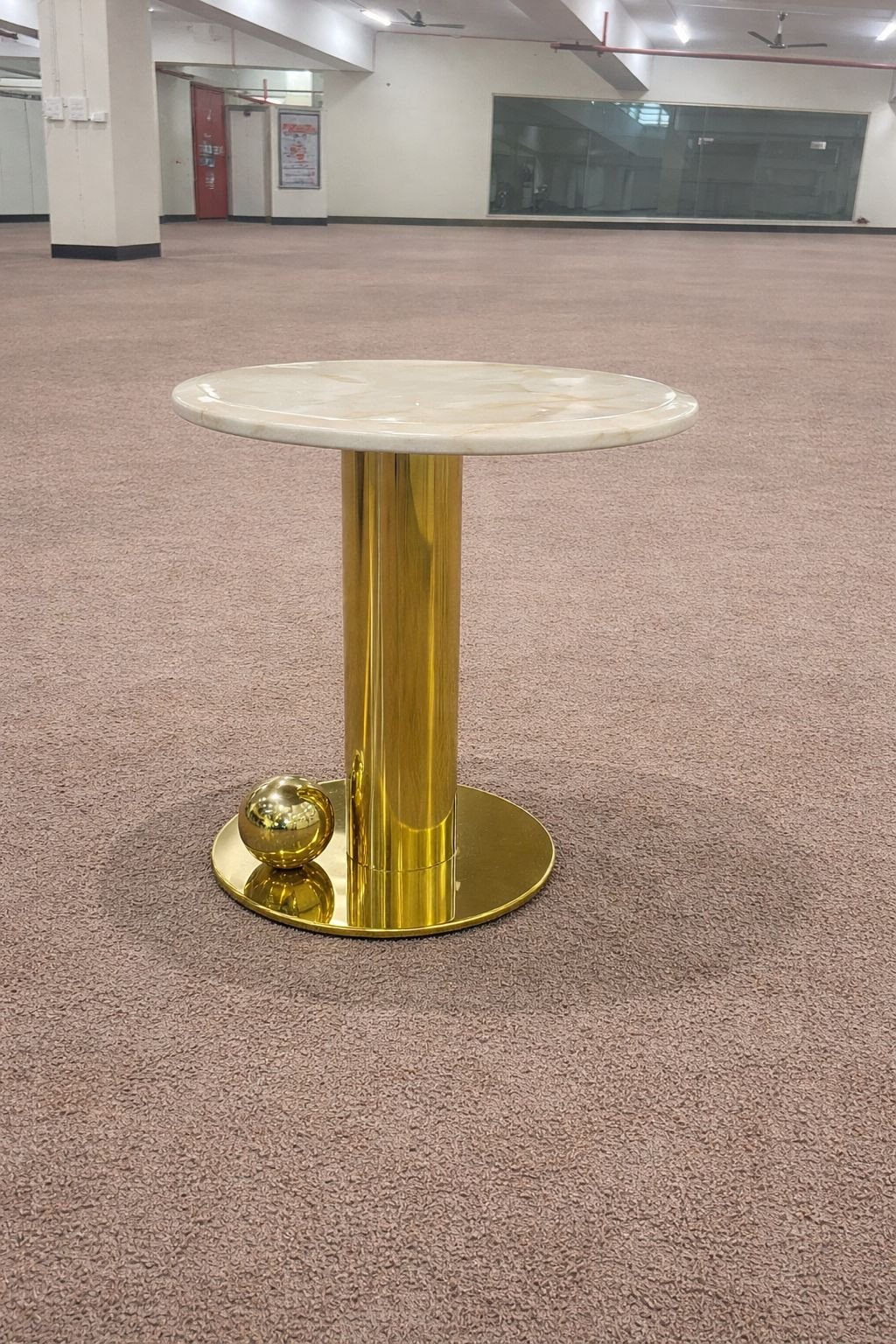 Round coffee table with a marble top and a gold finished metal base